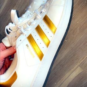 White and gold ADIDAS superstars
